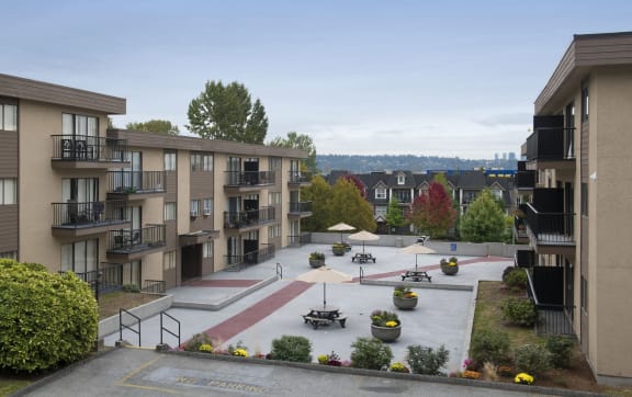 an aerial view of an apartment complex with an outdoor courtyard