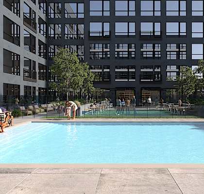 A swimming pool with people in it and a building behind it. at Anthem at Square 10 in New Haven, CT 06511