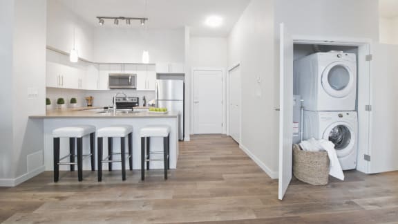 a white kitchen with a washing machine and a washer and dryer in it
