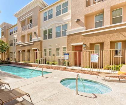 A pool area with chairs and a sign that says "Rent".