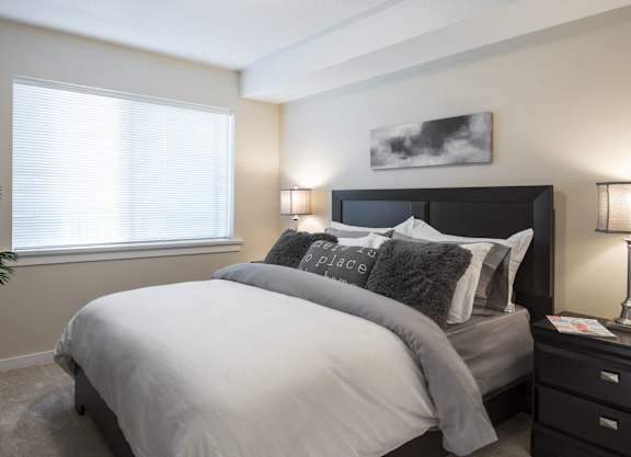 a bedroom with a large bed and a window
