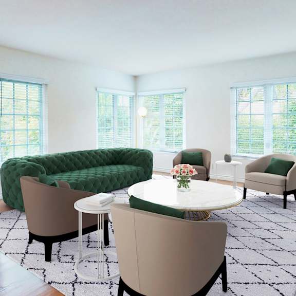 A living room with a green sofa and a white table.