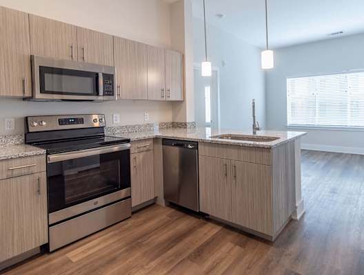 A kitchen with wooden cabinets and stainless steel appliances.