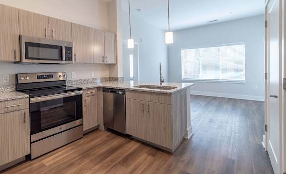 Modern kitchen featuring stainless steel appliances at NOVI in Concord, NC