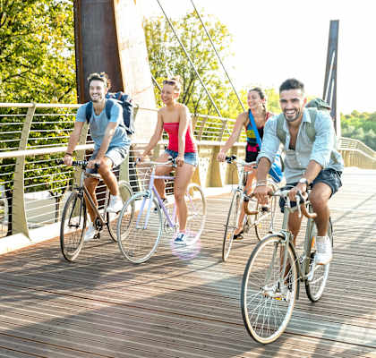 Four people riding bikes on a wooden bridge. at The Edge, California, 95928