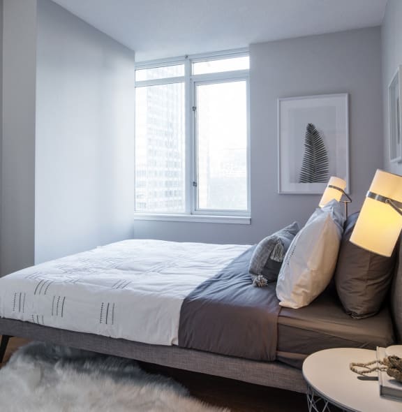 a bedroom with a large bed and a mirror