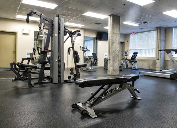 a fitness room with weights and other exercise equipment