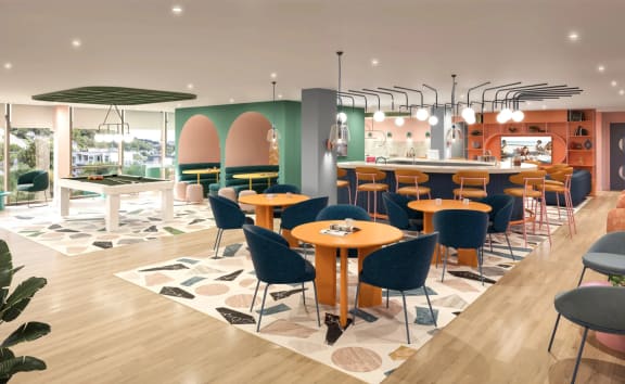 a view of the restaurant with tables and chairs and a bar in the background