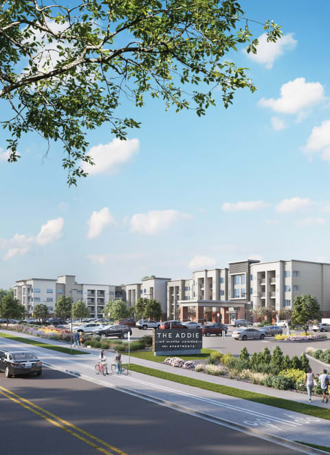 a dog and a cat are sleeping on a bed at The Addie at Metro Center 55+ Apartments, Aurora
