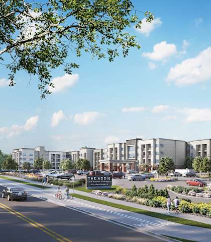 a rendering of a development of townhouses and apartments on a city street at The Addie at Metro Center 55+ Apartments, Aurora, Colorado