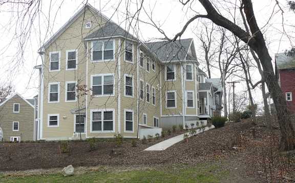 A large two-story house with a grey roof and white trim.
