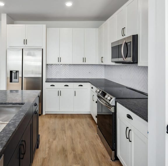 Sophisticated kitchen with large island and stainless steel appliances at Novel Harpeth Heights