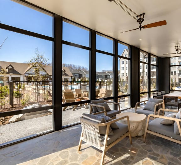 Beautiful enclosed outdoor area with floor-to-ceiling windows and plenty of seating at Novel Harpeth Heights