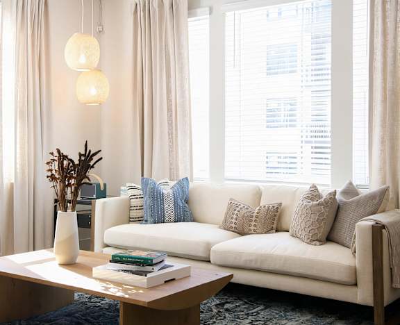 Cozy living room with giant windows and modern finishes at Novel Cary
