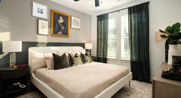 Spacious bedroom with feature wall adorned with deep green panel at Novel Harpeth Heights
