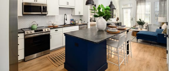 Modern kitchen area with wood-style floors and tall ceilings at Novel Harpeth Heights