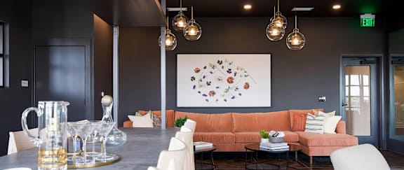 Modern bar-style seating area with comfy sofa and delicate lighting at Novel Cary