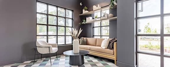 Modern coffeehouse-style social area with seating and full kitchen at Novel Cary