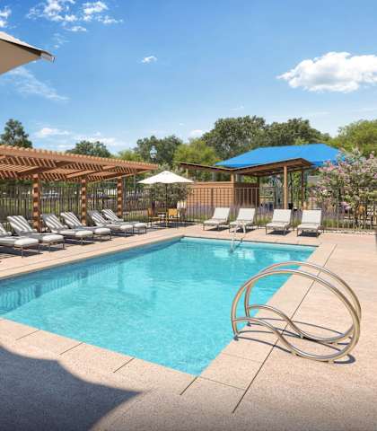 A pool area with sun loungers and a wooden pergola.