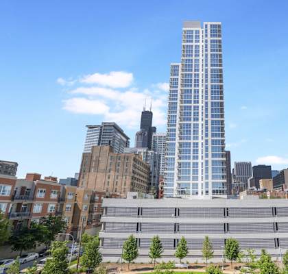 an aerial view of a tall skyscraper in the city at The Elle Apartments in West Loop, Chicago, Illinois 60605