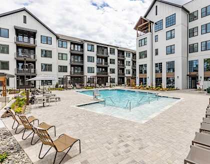 our apartments have a large pool and lounge chairs around it