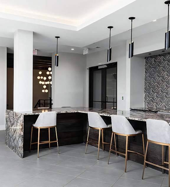 Modern Resident Lounge With Marble Bar and Contemporary Lighting at The Harper