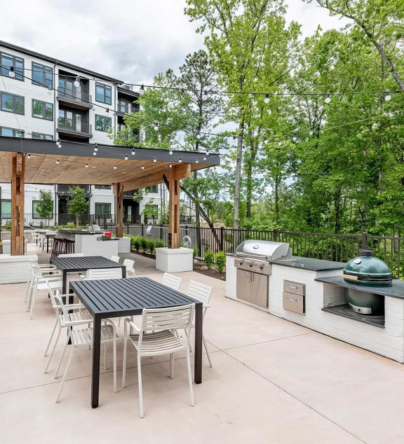 Fun and beautiful outdoor kitchen and seating areas with standard and ceramic grills at Novel Cary