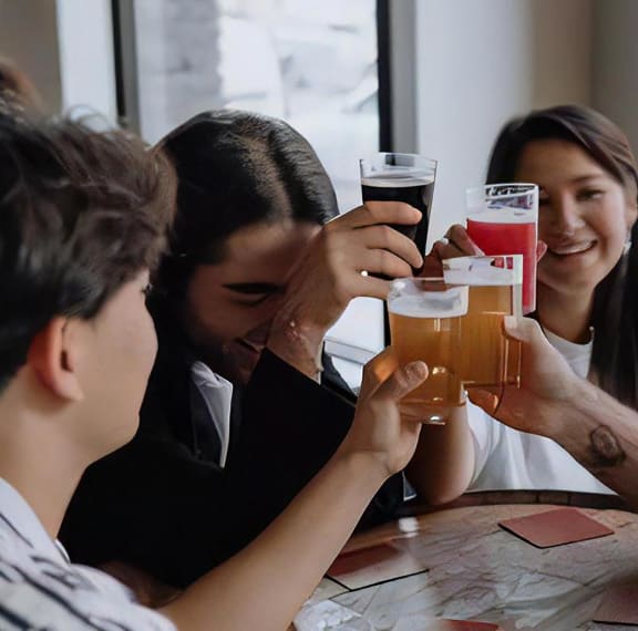 People Toasting Drinks At Table Close Up