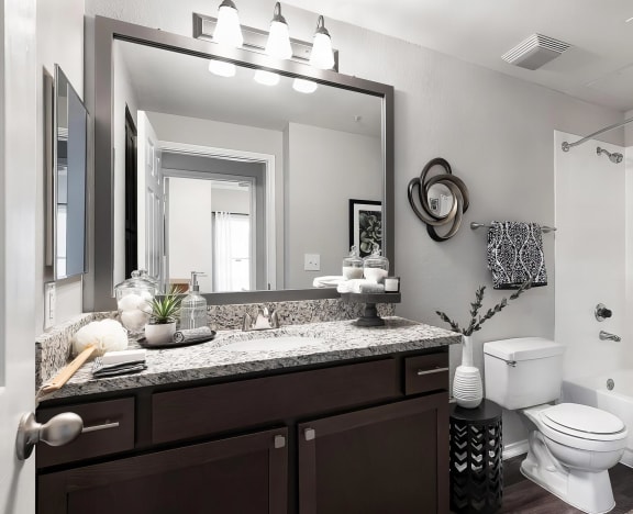 Mesa Verde Bathroom Upgraded Bathroom with Granite Vanity Framed Mirror Curved Shower Curtain Rod