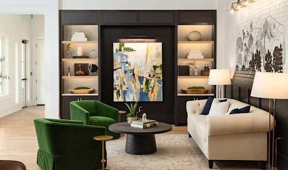 A living room with a green chair, a white sofa, and a coffee table.