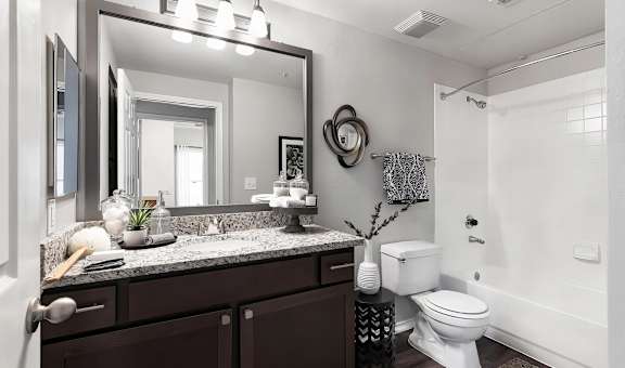 Mesa Verde Bathroom Upgraded Bathroom with Granite Vanity Framed Mirror Curved Shower Curtain Rod