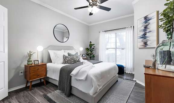 Mesa Verde Bedrooms Bright and Spacious Bedroom with Wood Look Vinyl Flooring Ceiling Fan and Crown Molding
