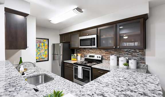 Mesa Verde Kitchen Upgraded Kitchen with Bar Top Granite Countertops Shaker Cabinets Stainless Appliances Undermount Sink