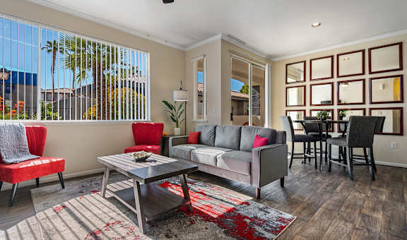 a living room with a couch and chairs and a table
