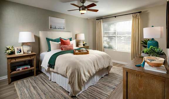 Seacrest Bedroom Large Windows Allow in Plentiful Natural Light Featuring 2 Faux Wood Blinds