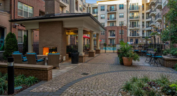 a patio with a fire pit and a building with apartments at 401 Oberlin, Raleigh, 27605