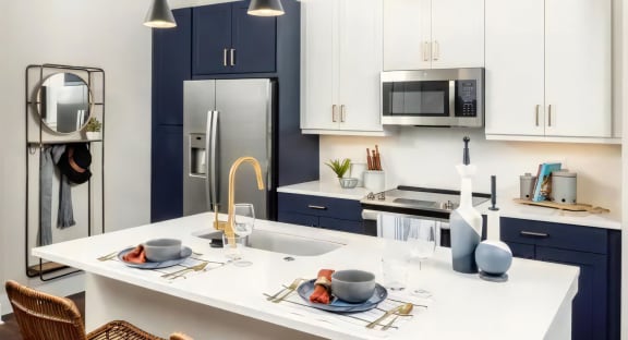 Broadstone Upper Westside Apartments Kitchen Island Kitchen with Breakfast Bar Ample Cabinet Space and Self Closing Drawers