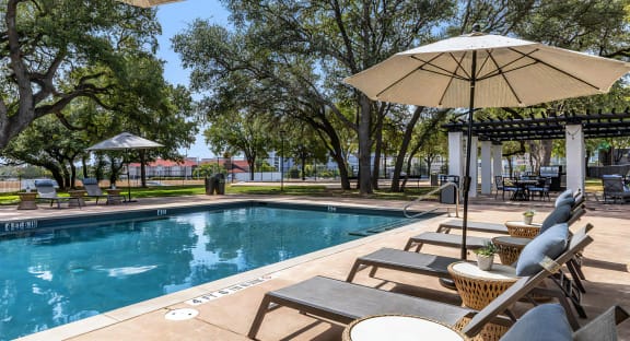 Mesa Verde Pool Second Pool with Sunbathing Loungers Shade Umbrellas and Adjacent Outdoor Covered Lounge