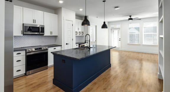 Spacious open floor plan with large kitchen island and industrial lighting at Novel Harpeth Heights