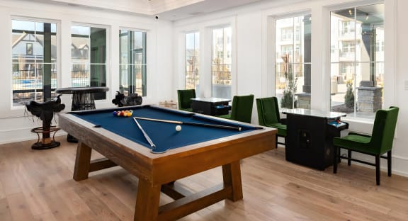 Bright game area with pool table and arcade tables at Novel Harpeth Heights