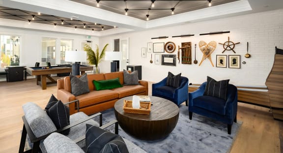 Intimate and comfy social seating area with a game-themed backdrop at Novel Harpeth Heights