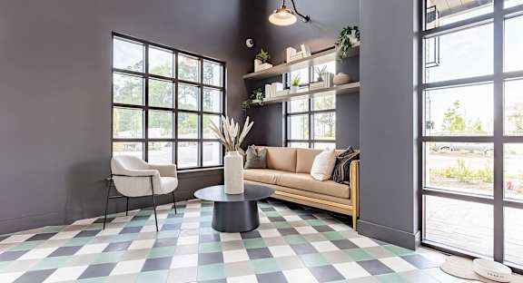 Cozy entryway with cozy seating area and pet water bowl at Novel Cary