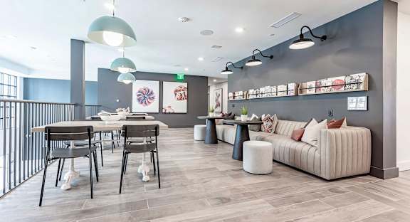 Cozy reading area with extra large sofa and magazine rack at Novel Cary