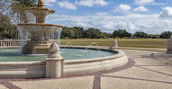 A large fountain in the middle of a park.