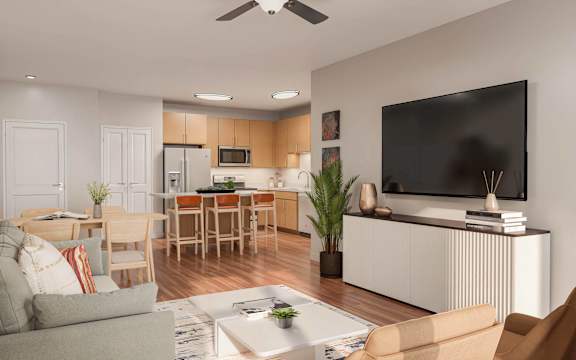 A modern living room with a grey couch, a wooden dining table, and a flat-screen TV mounted on the wall at Sage at Franklin Park Apartment , Austin, 78744
