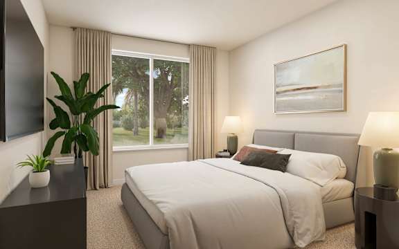 A bedroom with a large bed, a plant, and a painting on the wall. at The Mira Apartments, Florida