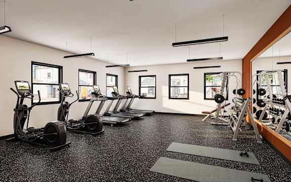 A gym with a row of treadmills and elliptical machines at Sidney Village, Buckeye, AZ