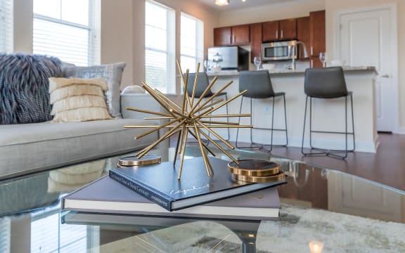 living room with open kitchen and island with granite countertops