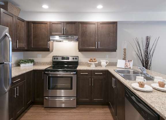 a kitchen with stainless steel appliances and granite counter tops