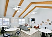 Thumbnail 3 of 16 - clubhouse lounge area with tables, a couch, and tv at canterbury house apartments in warsaw